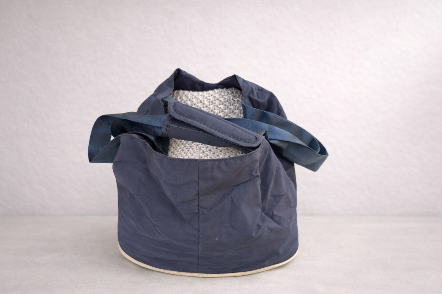 The Hollydaz navy dog carrier bag shown open from the front, with padded grey base and shoulder straps