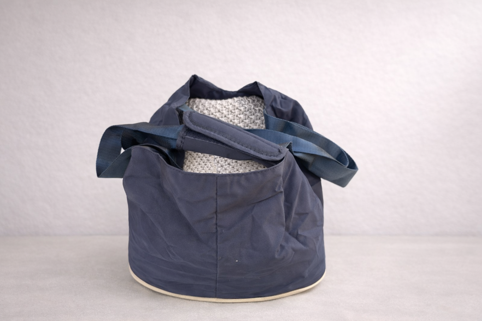 The Hollydaz navy dog carrier bag shown open from the front, with padded grey base and shoulder straps